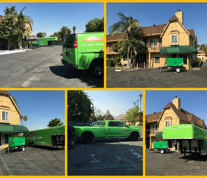 SERVPRO vehicles parked outside hotel.