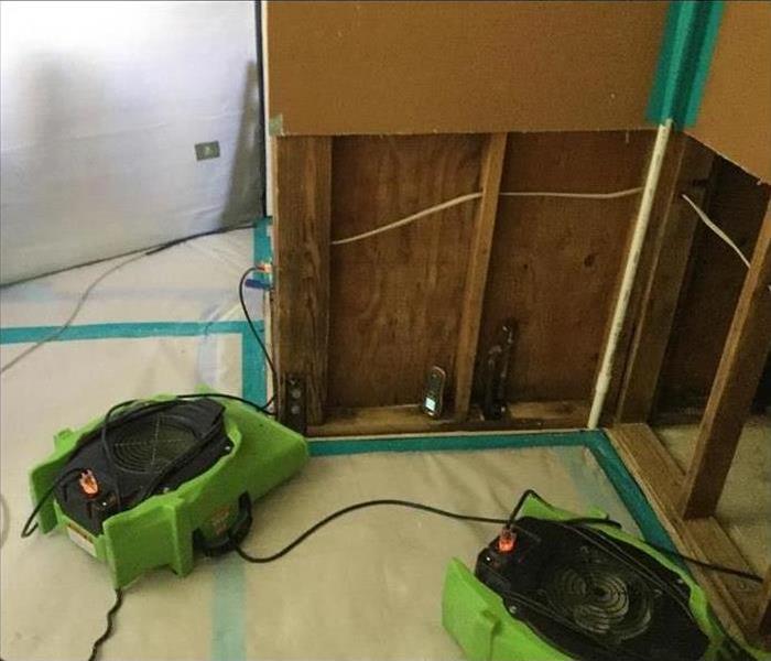 two air movers placed on affected area by water, flood cut performed on drywall.