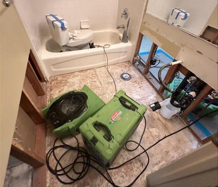 Drying equipment in a bathroom with flood cuts.