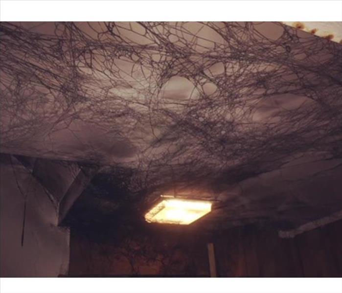 soot webs on ceiling. Concept puffback damage